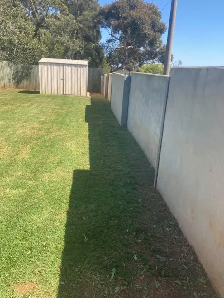 Residential backyard with fencing and landscaping